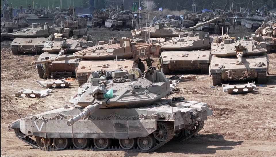 a row of military tanks with one that has the letter v on it