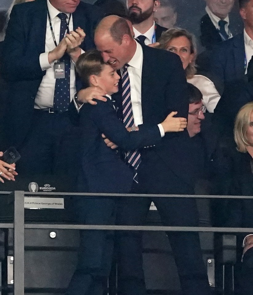 a man in a suit and tie is hugging a young boy in the stands