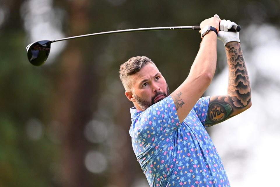 a man with a tattoo on his arm is swinging a golf club