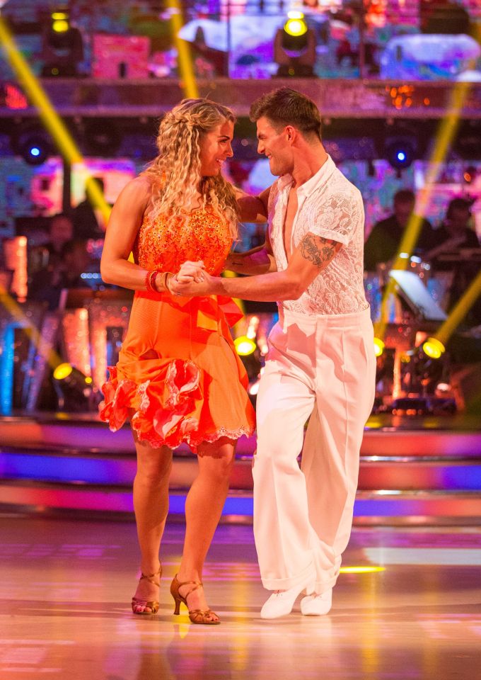 a man and a woman are dancing on a dance floor