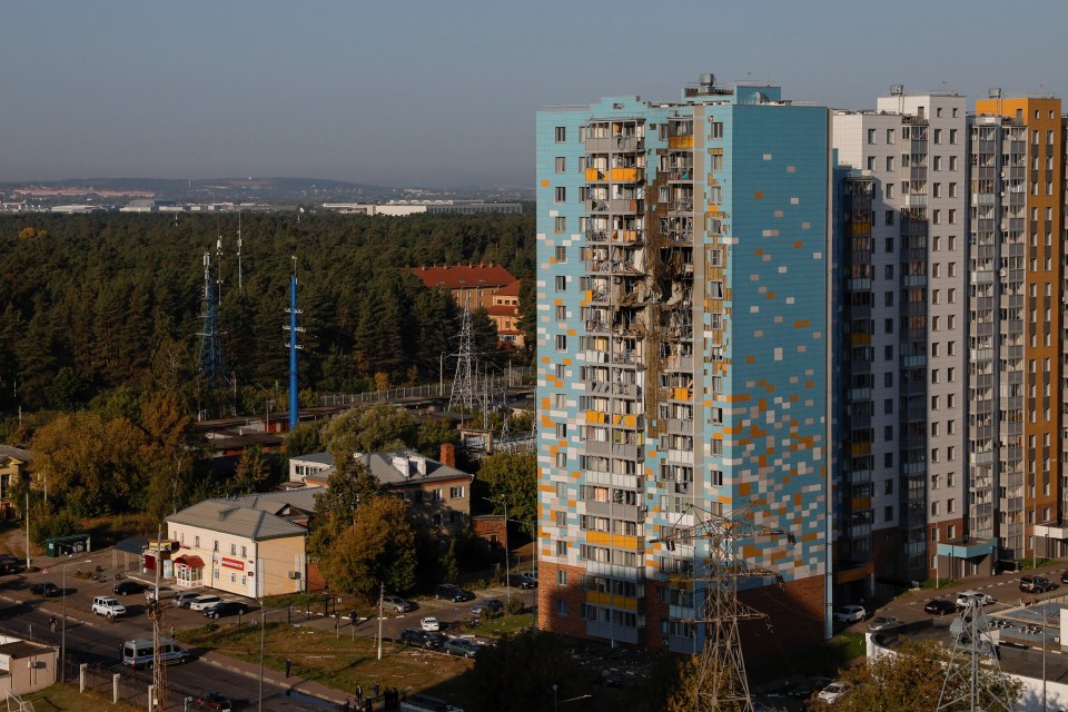 a very tall building with a blue and yellow facade