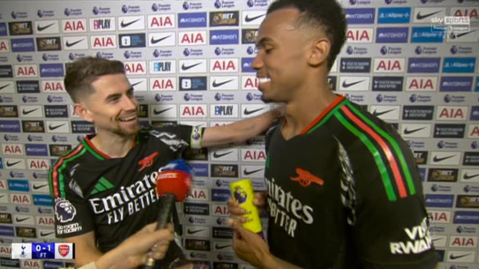 two soccer players are standing in front of a wall that says aia