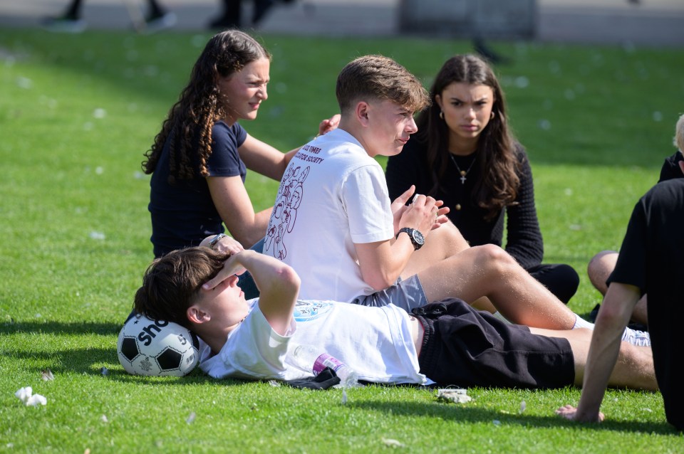 a boy laying on the grass with a soccer ball that says sirius on it
