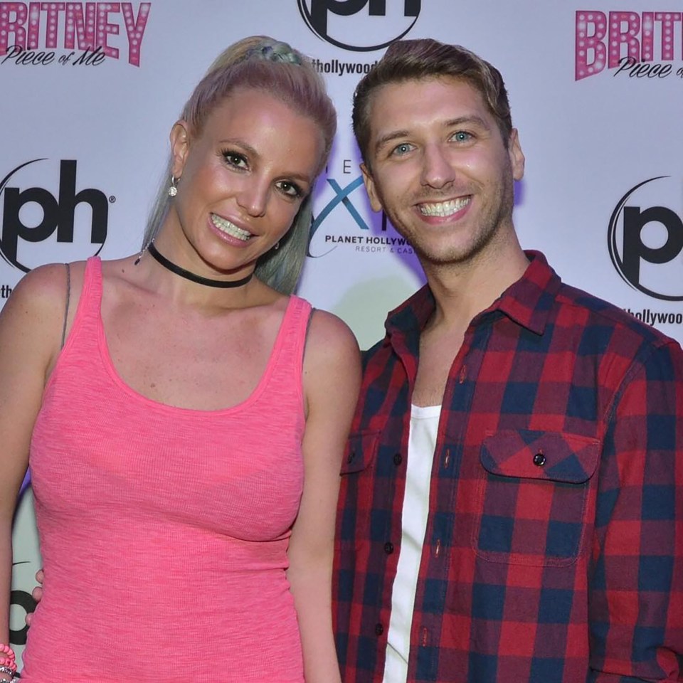 a woman in a pink tank top and a man in a plaid shirt pose for a photo