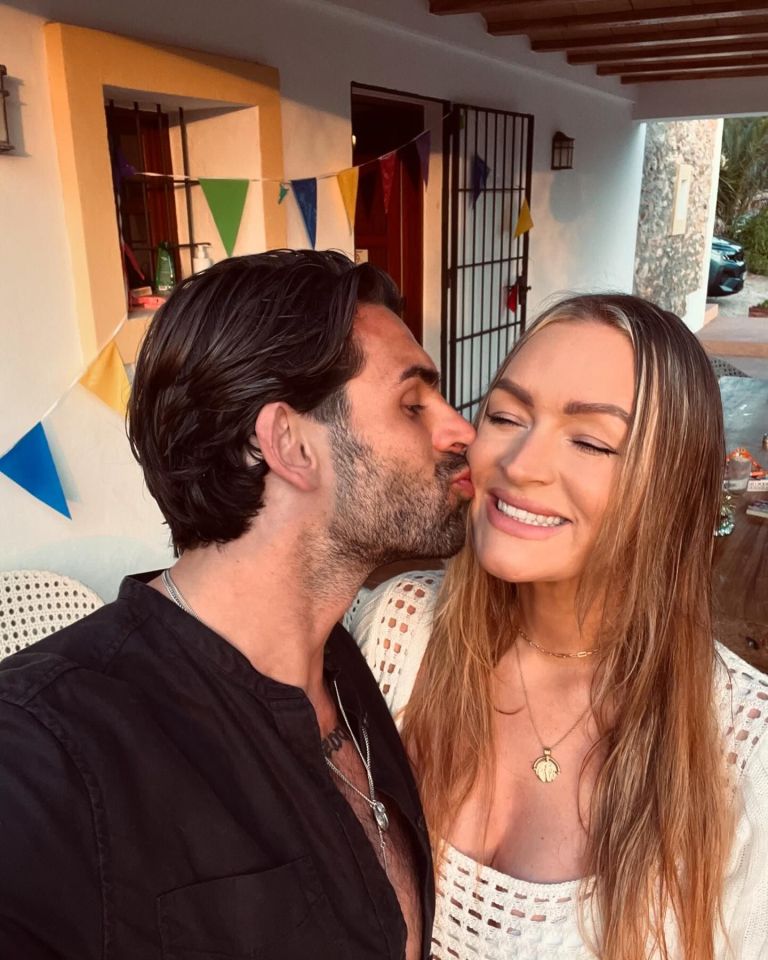 a man is kissing a woman on the cheek