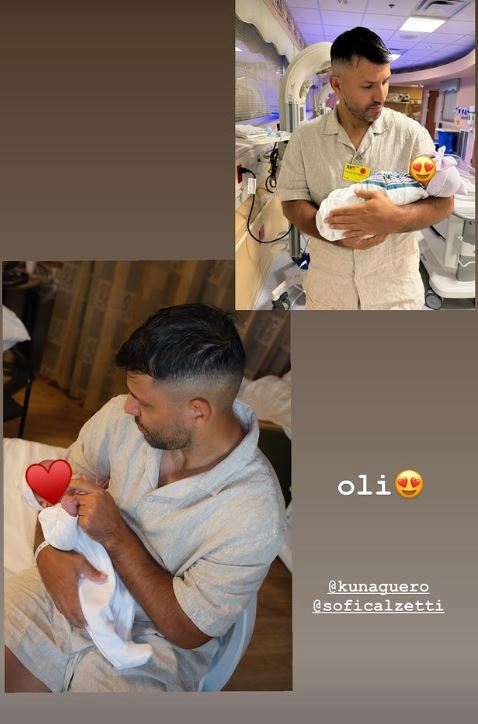 a man is holding a newborn baby in a hospital