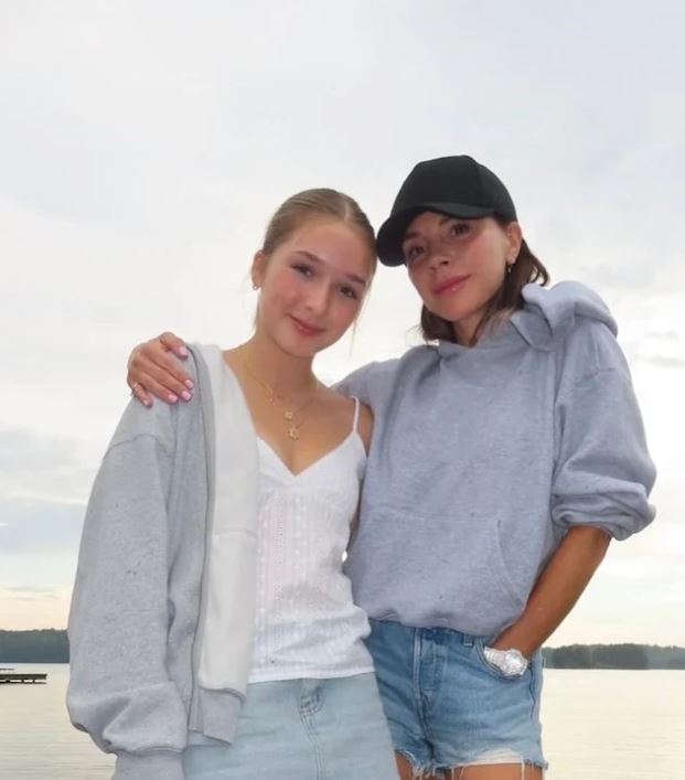 two girls posing for a picture with one wearing a black hat