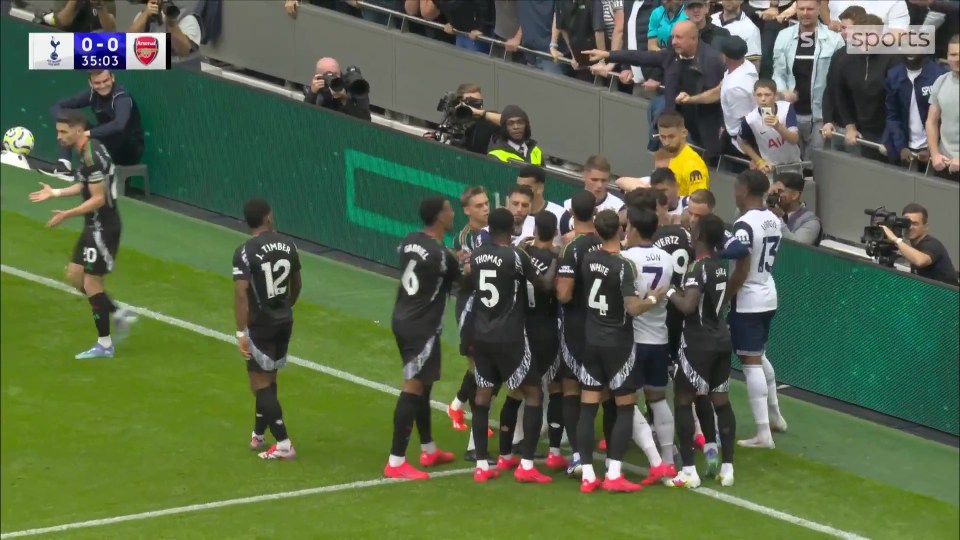 a group of soccer players on a field with one wearing the number 12