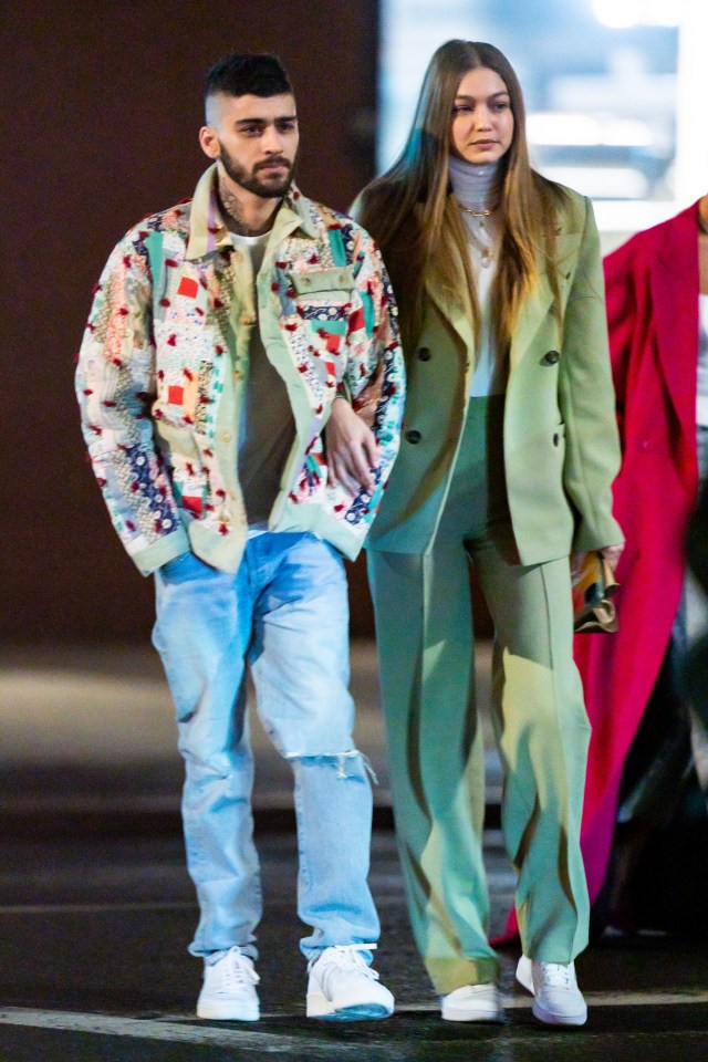 a man and a woman are walking down the street