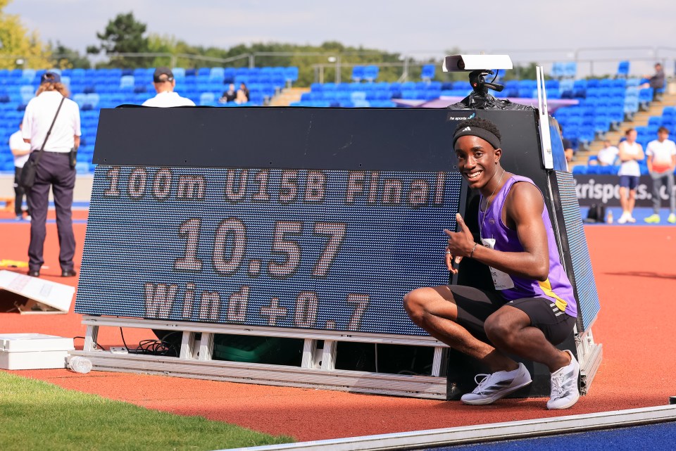 a man is kneeling in front of a sign that says 100m u15b final