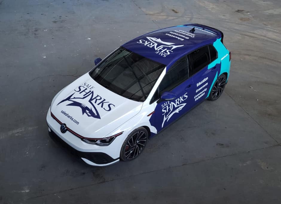 a blue and white car that says safe sharks on it