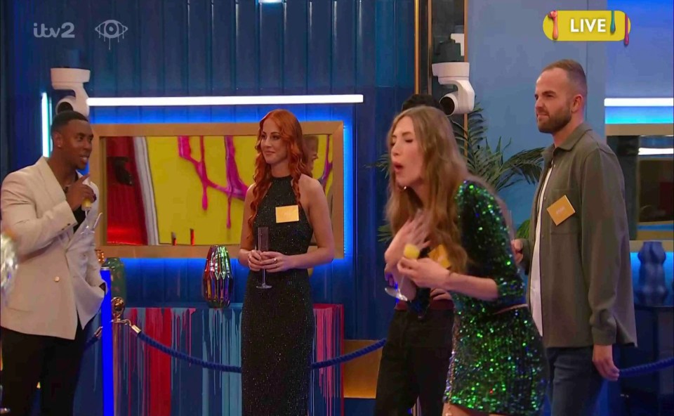 a group of people standing in a room with a live sign above them