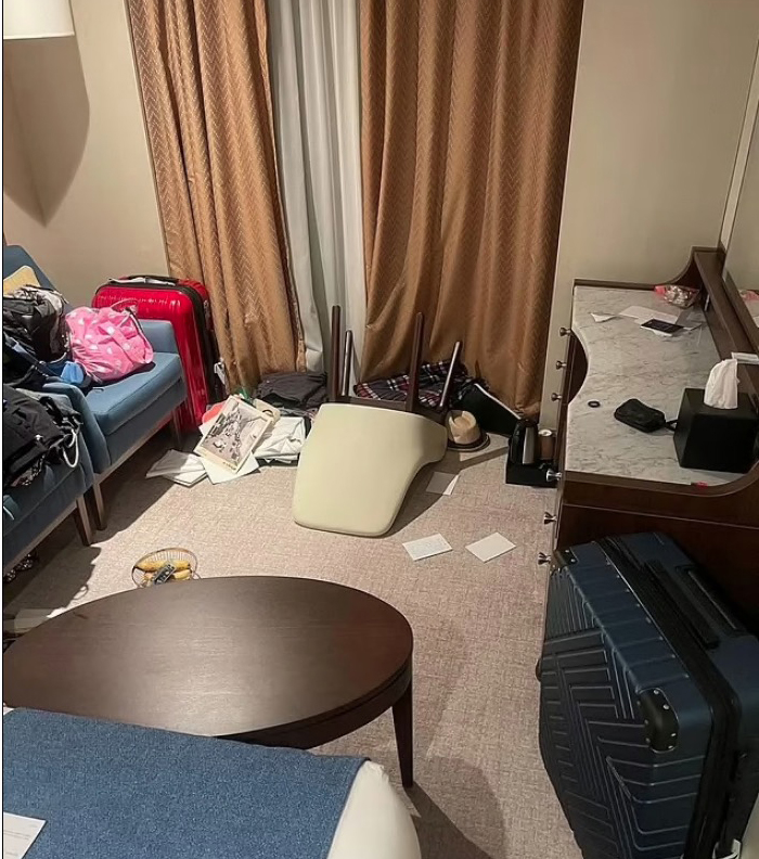 a messy room with a chair on the floor