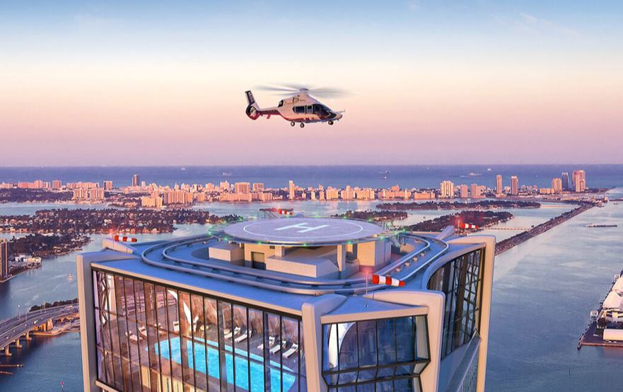 a helicopter is flying over a building with the letter h on it