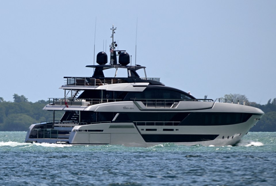 a large white and black yacht is floating on the water