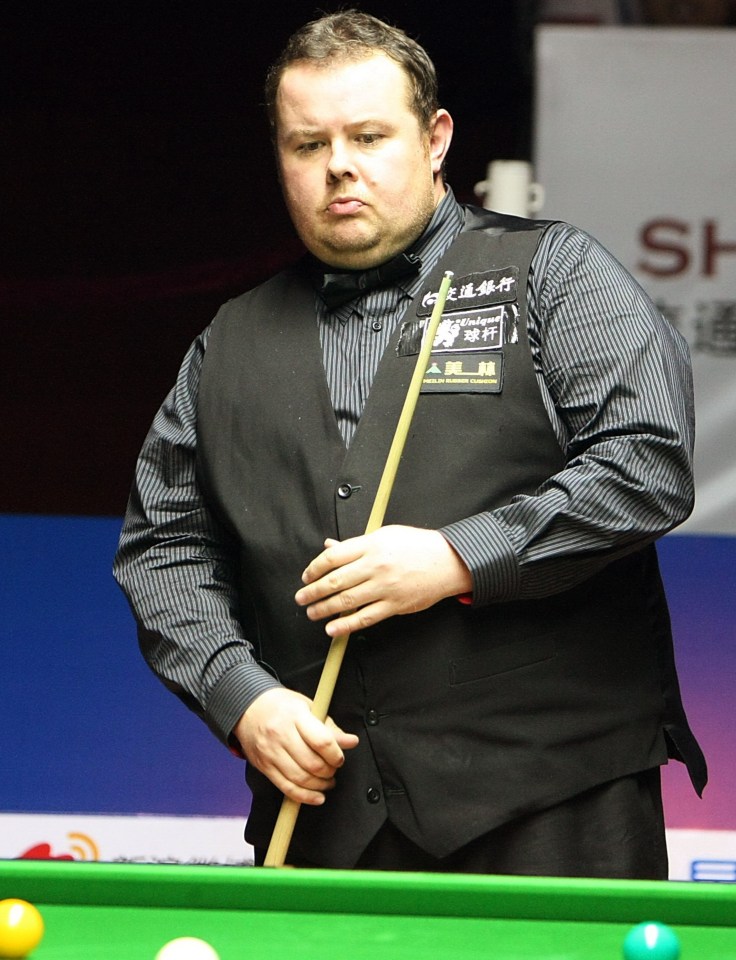 a man holding a pool cue with chinese writing on his vest