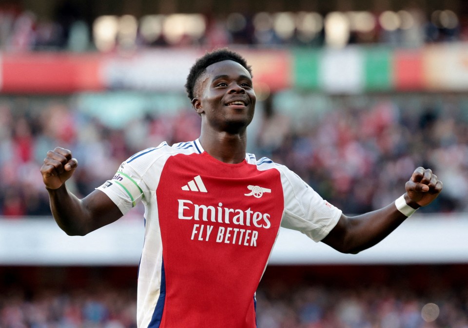 a soccer player wearing an emirates fly better jersey