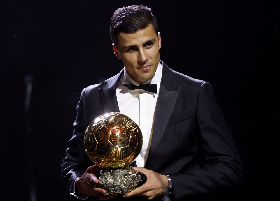 a man in a tuxedo is holding a soccer ball