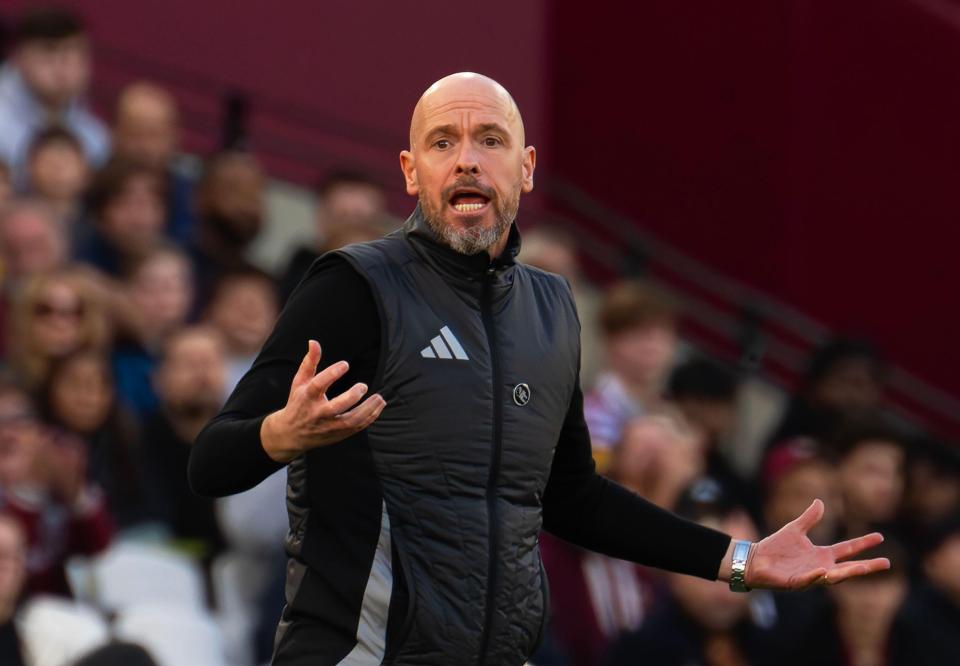 a bald man wearing an adidas vest stands in front of a crowd