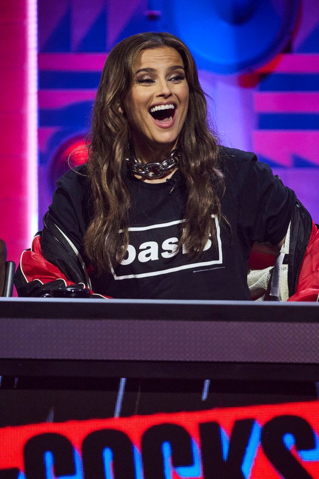 a woman wearing a black shirt that says oasis on it