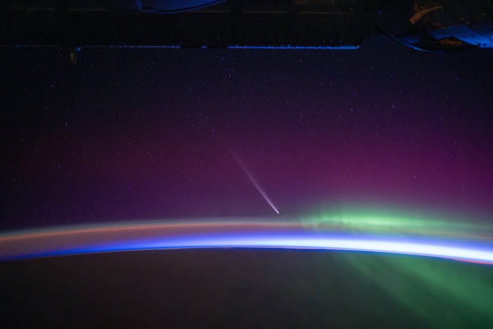 the aurora borealis is visible in the night sky above the earth
