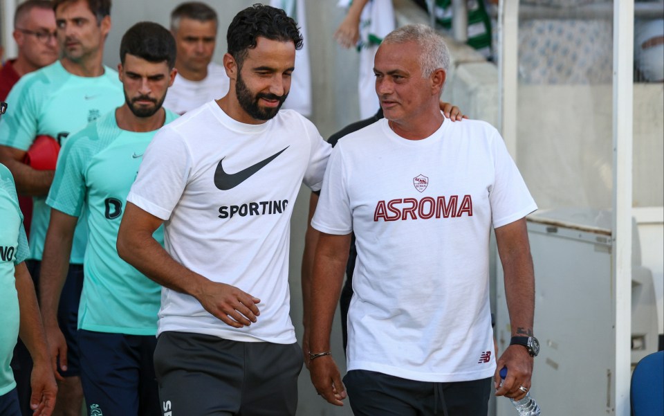 a man wearing a shirt that says asroma walks with another man