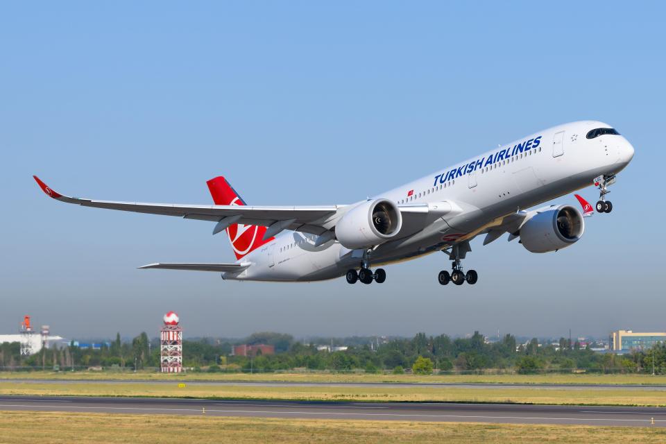 a turkish airlines plane is taking off from the runway