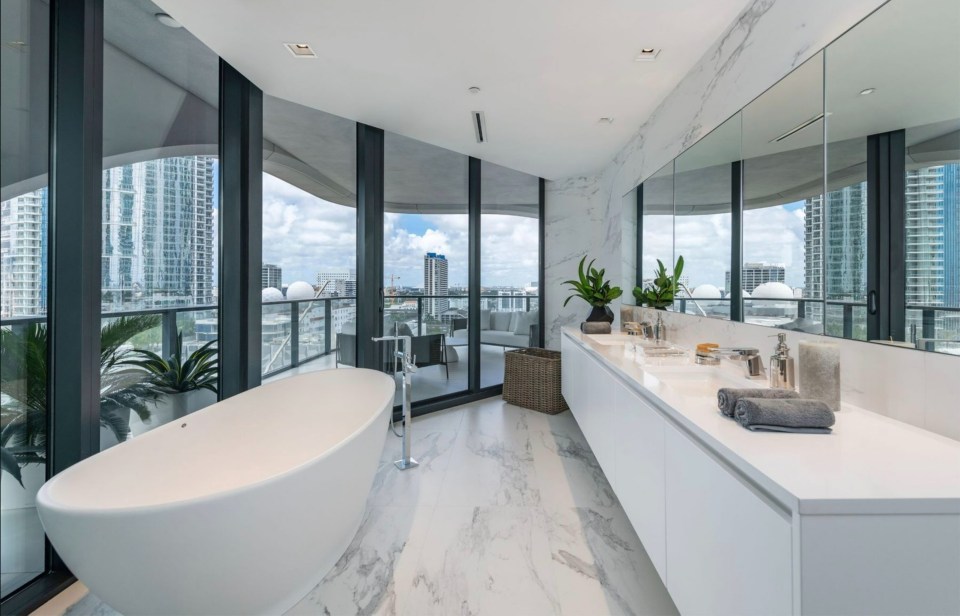 a bathroom with a large tub and two sinks
