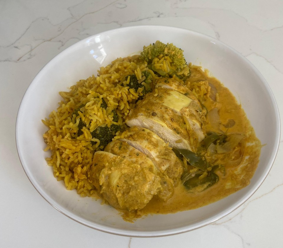a white plate topped with rice chicken and broccoli