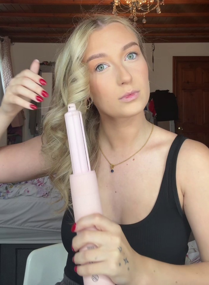 a woman is holding a hair straightener in her hand and says " pov "