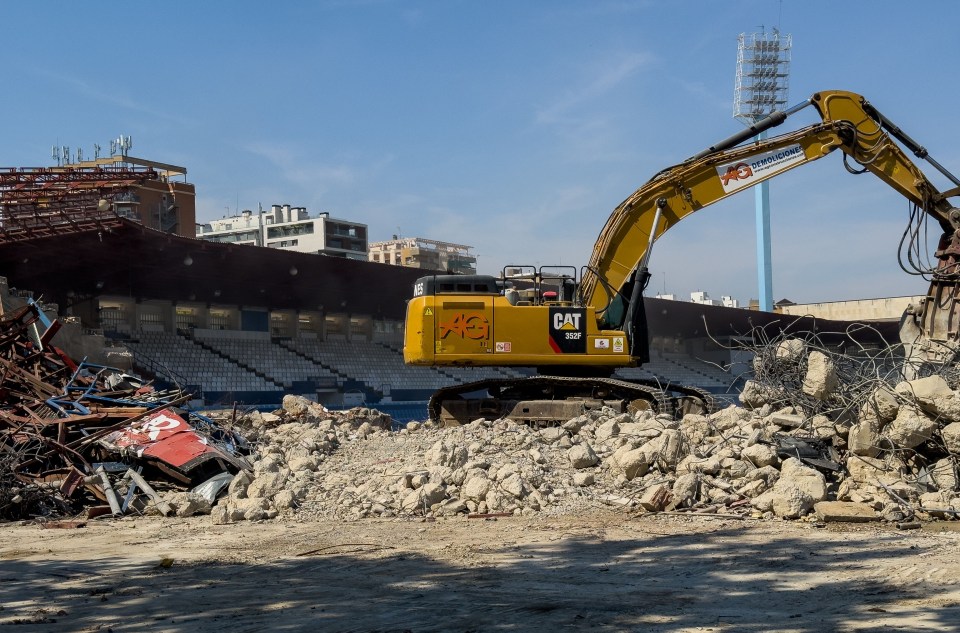 a yellow excavator with the word cat on it