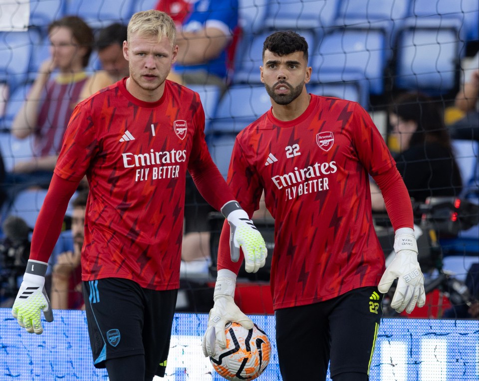 two soccer players wearing emirates fly better jerseys stand next to each other