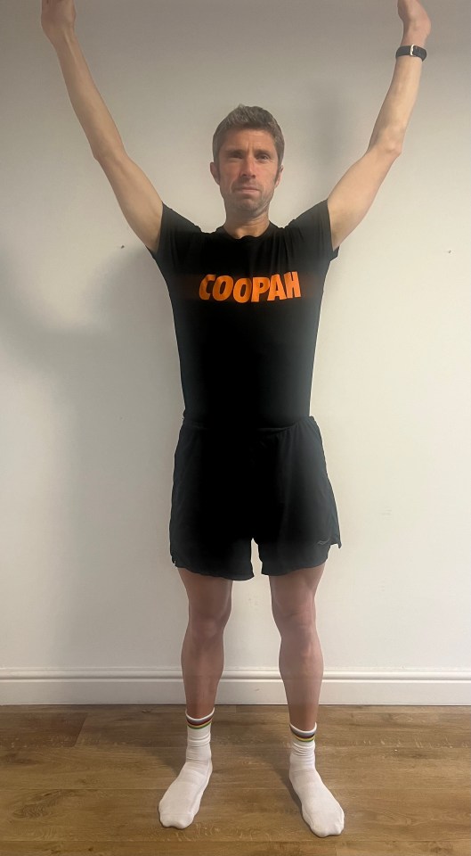 a man wearing a black shirt that says coopah