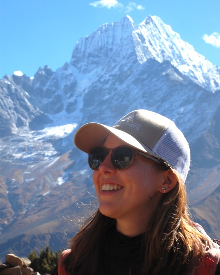 a woman wearing a hat that says ' altitude ' on it