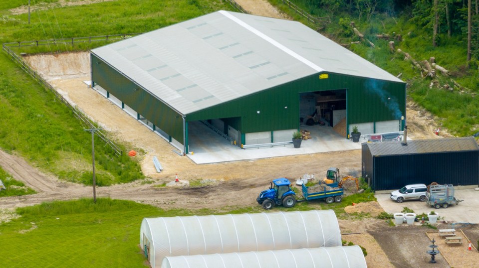 an aerial view of a green building with a yellow sign that says ' warehouse ' on it
