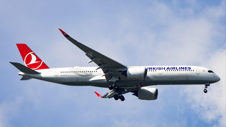 a turkish airlines plane is flying in the sky