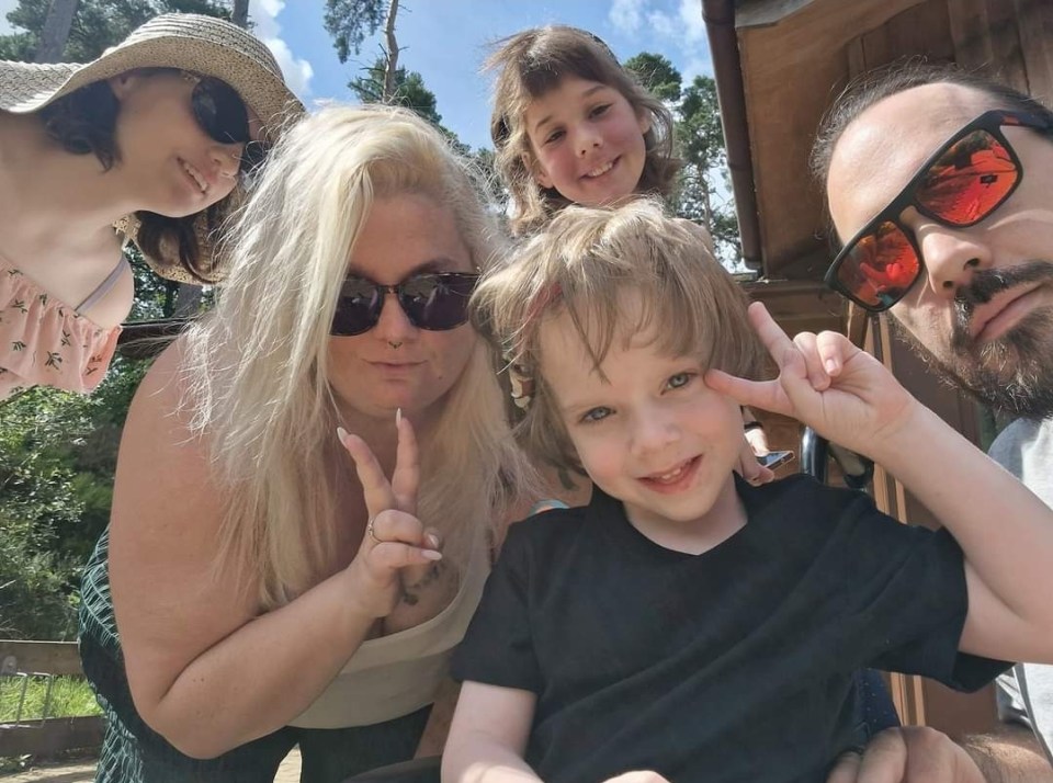 a group of people posing for a picture one of whom is wearing sunglasses