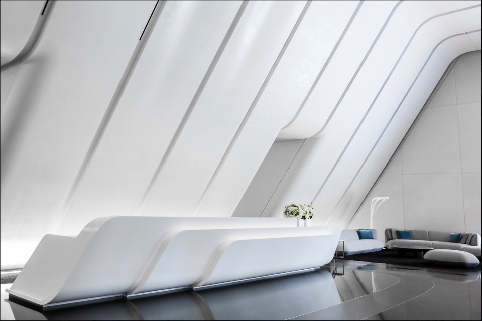 a white reception area with a curved ceiling