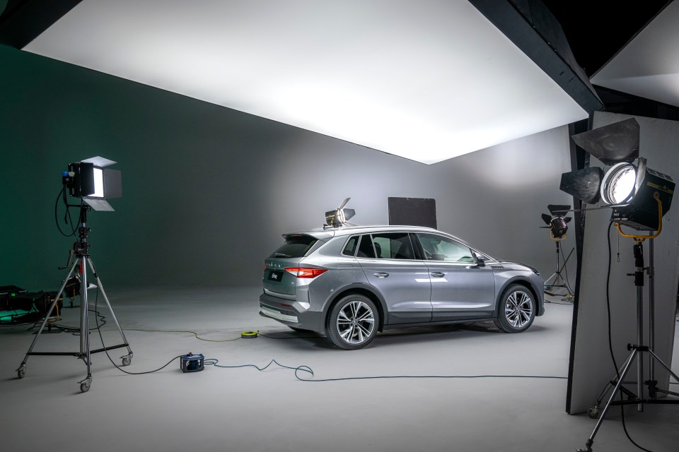 a silver suv is being photographed in a studio