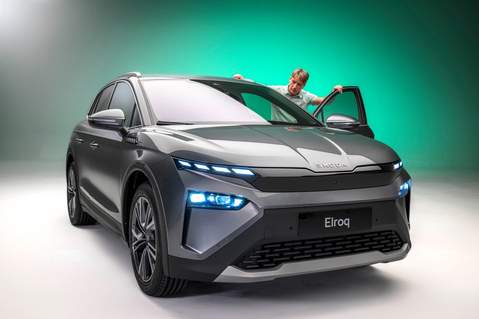 a man opens the door of a skoda eiroq