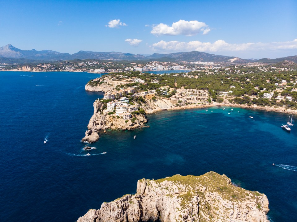 an aerial view of a large body of water with mountains in the background