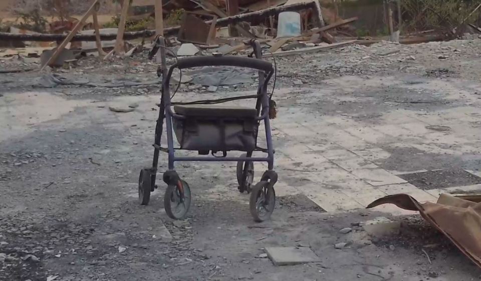 a walker is sitting in a pile of rubble