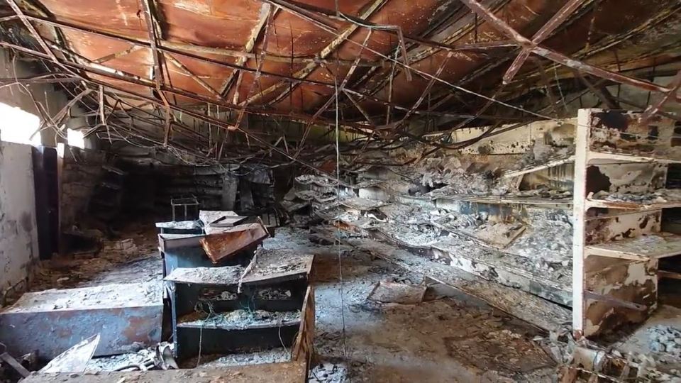 the inside of an abandoned building with a lot of shelves