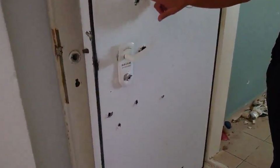a white door with holes in it and a sign that says bazar