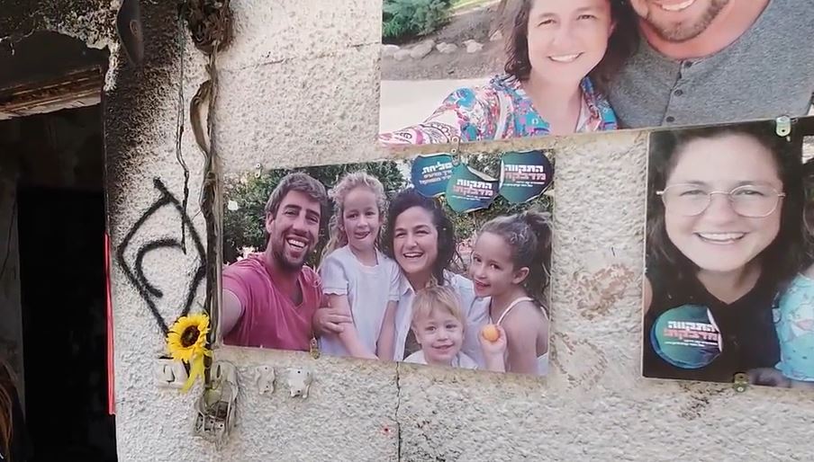 a wall with a bunch of pictures on it including one of a family