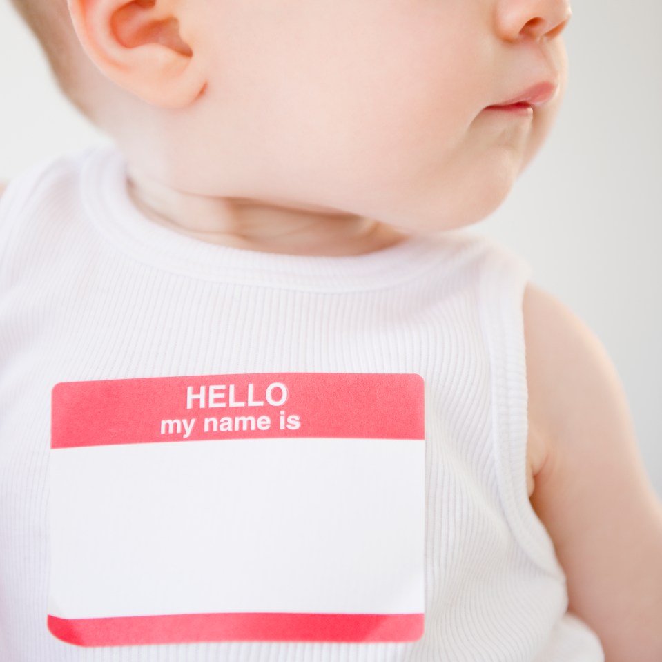 a baby wearing a name tag that says hello my name is