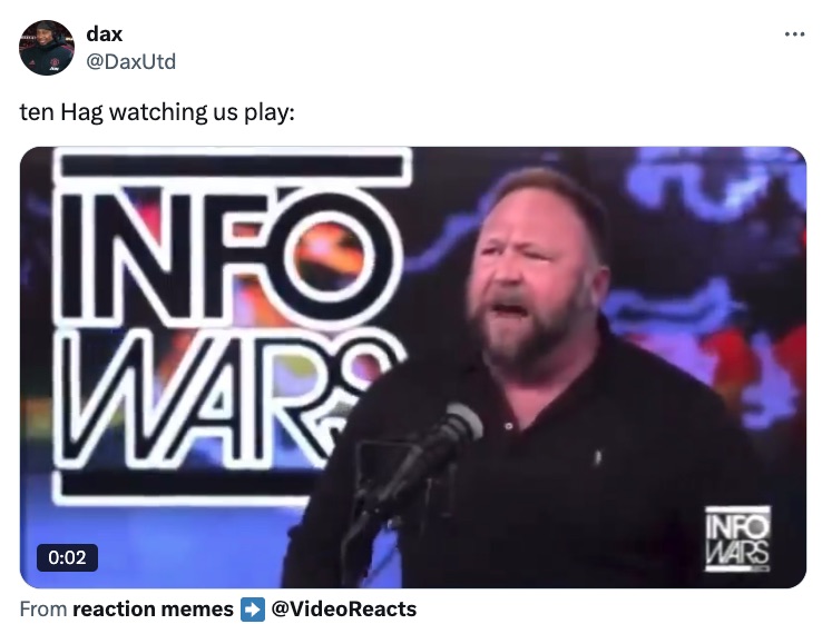 a man stands in front of a microphone in front of a sign that says info wars