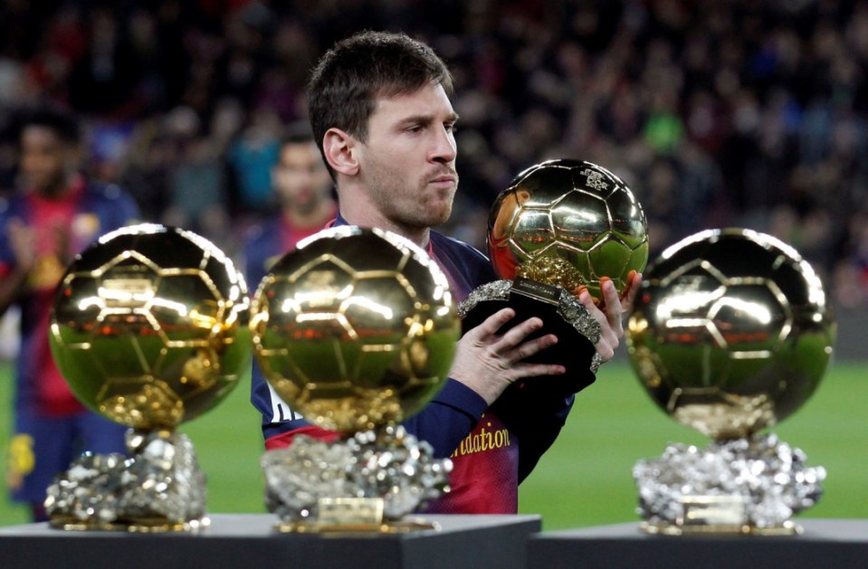 FILE PHOTO: Barcelona's soccer player Lionel Messi poses with his four Ballon d'Or (Golden Ball) trophies before their Spanish King's Cup soccer match against Malaga at Nou Camp Stadium in Barcelona January 16, 2013. REUTERS/ Albert Gea/File Photo