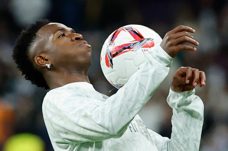 (FILES) Real Madrid's Brazilian forward #07 Vinicius Junior warms up before the Spanish league football match between Real Madrid CF and FC Barcelona at the Santiago Bernabeu stadium in Madrid on October 26, 2024. Real Madrid's Brazilian striker Vinicius Jr could be the next winner of the Ballon d'Or on Monday, at the ceremony for the prestigious award, which could well be won for the second year running by Spain's Aitana Bonmati. (Photo by OSCAR DEL POZO / AFP) (Photo by OSCAR DEL POZO/AFP via Getty Images)