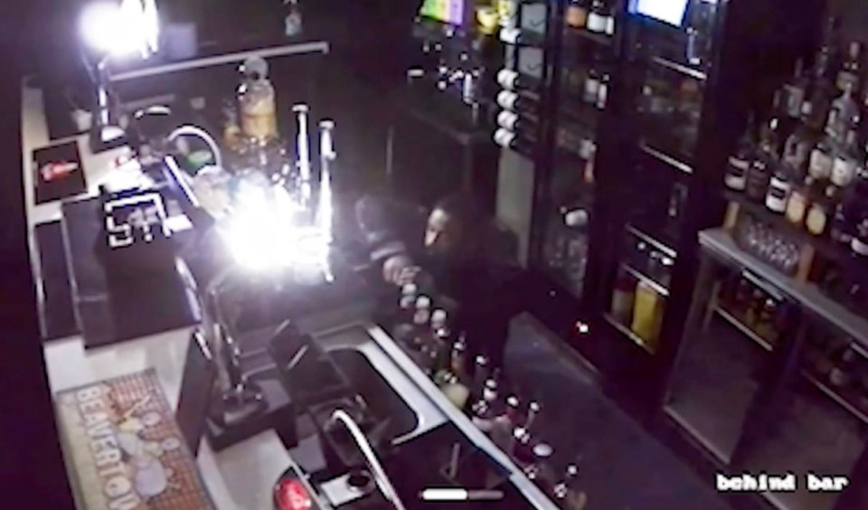 Brazen Shamsul Islam fills his pockets from the till of a bar. Release date October 30 2024. A bungling burglar who was captured crawling around pubs and restaurants in an attempt to evade CCTV cameras has been jailed. Shamsul Islam, 40, stole thousands of pounds in cash and property after breaking into seven different businesses while creeping about on all fours. And while the dopy thief thought his technique had concealed his identity, cameras in the commercial properties, in Bury, Grtr. Manchester, caught his every move. He was eventually rumbled when a restaurant owner received a phone alert that someone was inside his premises at 2.15am and watched the burglary unfold. Islam disturbed an alarm at the premises and left a small amount of blood after smashing a glass during his frantic escape that helped police identify him.